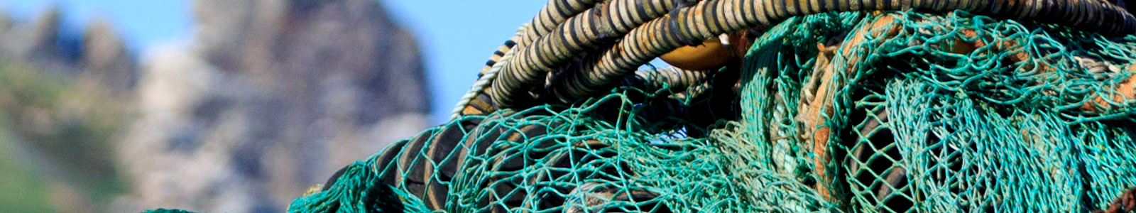 fishing gear and nets piled on pier